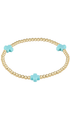 A gold beaded bracelet with three light blue cross charms, displayed on a clean white background.