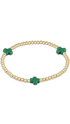 A gold beaded bracelet with three green cross charms, displayed on a clean white background.