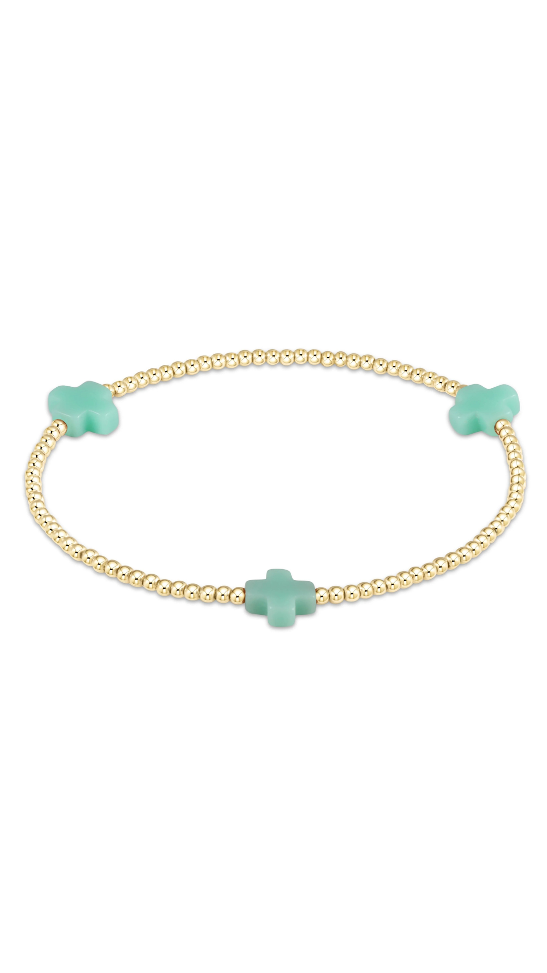 A delicate gold beaded bracelet featuring three mint green charms, including two small clover-shaped charms and one larger cross-shaped charm, displayed on a clean white background.