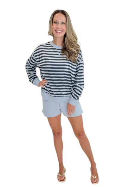 Front view of woman wearing Swagger Boutique’s Skyline The Everyday Short and Eclipse The Everyday Striped Crew by Z Supplyagainst white studio background.