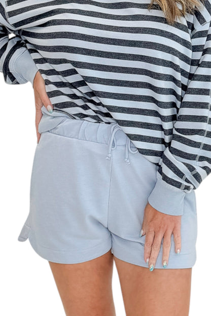 Front view of woman wearing Swagger Boutique’s Skyline The Everyday Short and Eclipse The Everyday Striped Crew by Z Supplyagainst white studio background.