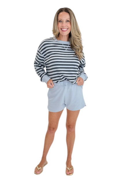Front view of woman wearing Swagger Boutique’s Skyline The Everyday Short and Eclipse The Everyday Striped Crew by Z Supplyagainst white studio background.