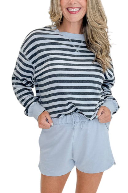 Front detail view of woman wearing Swagger Boutique’s Skyline The Everyday Short and Eclipse The Everyday Striped Crew by Z Supplyagainst white studio background.