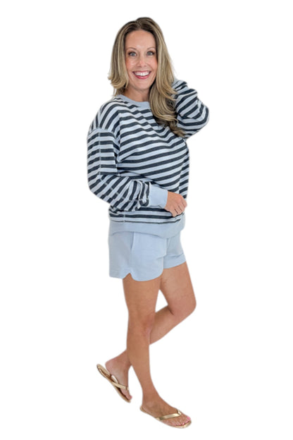 Side view of woman wearing Swagger Boutique’s Skyline The Everyday Short and Eclipse The Everyday Striped Crew by Z Supplyagainst white studio background.