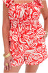 Front detail view of woman wearing Swagger Boutique’s Coral Printed Smocked Peplum Tank with matching Coral Printed Shorts against white studio background.