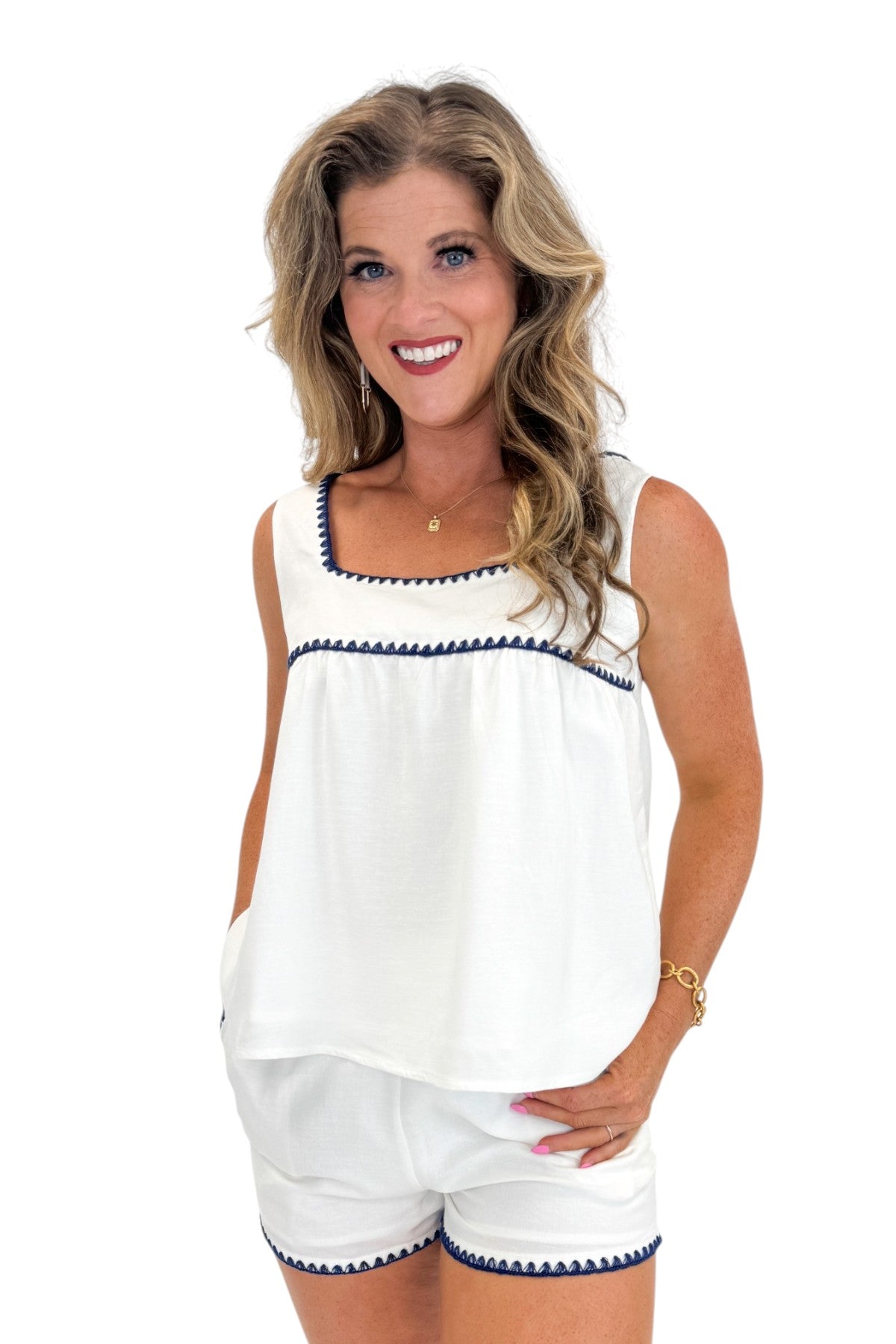 Front view of woman wearing Swagger Boutique’s White &amp; Blue Square Neck Stitch Detail Tank with matching shorts against white studio background.