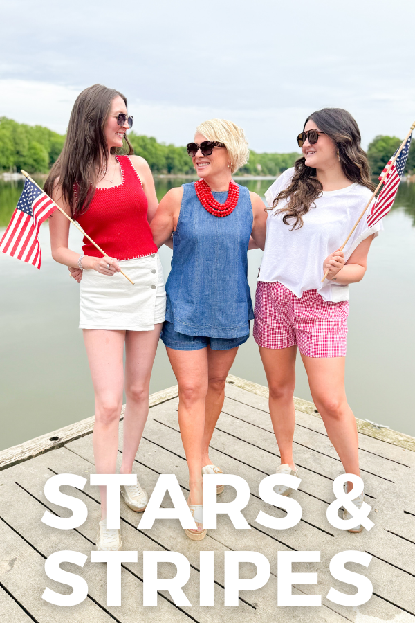 Three women on a dock holding American flags with 'Stars & Stripes' text.