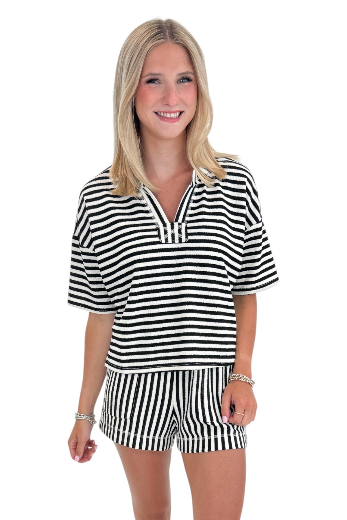 Front view of woman wearing Swagger Boutique’s Black &amp; White Striped Lounge Shorts with matching shorts against white studio background.