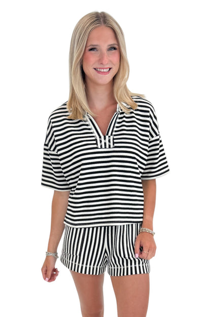 Front view of woman wearing Swagger Boutique’s Black &amp; White Striped Lounge Shorts with matching shorts against white studio background.