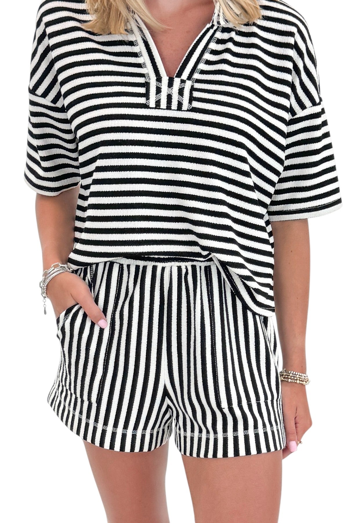 Front detail view of woman wearing Swagger Boutique’s Black &amp; White Striped Lounge Shorts with matching shorts against white studio background.