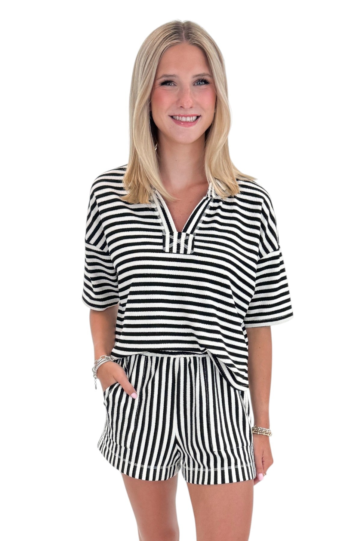 Front view of woman wearing Swagger Boutique’s Black &amp; White Striped Lounge Shorts with matching shorts against white studio background.