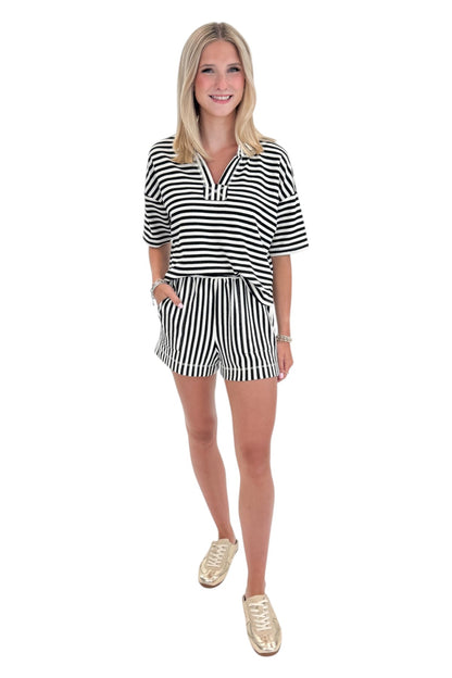 Front view of woman wearing Swagger Boutique’s Black &amp; White Striped Lounge Shorts with matching shorts against white studio background.