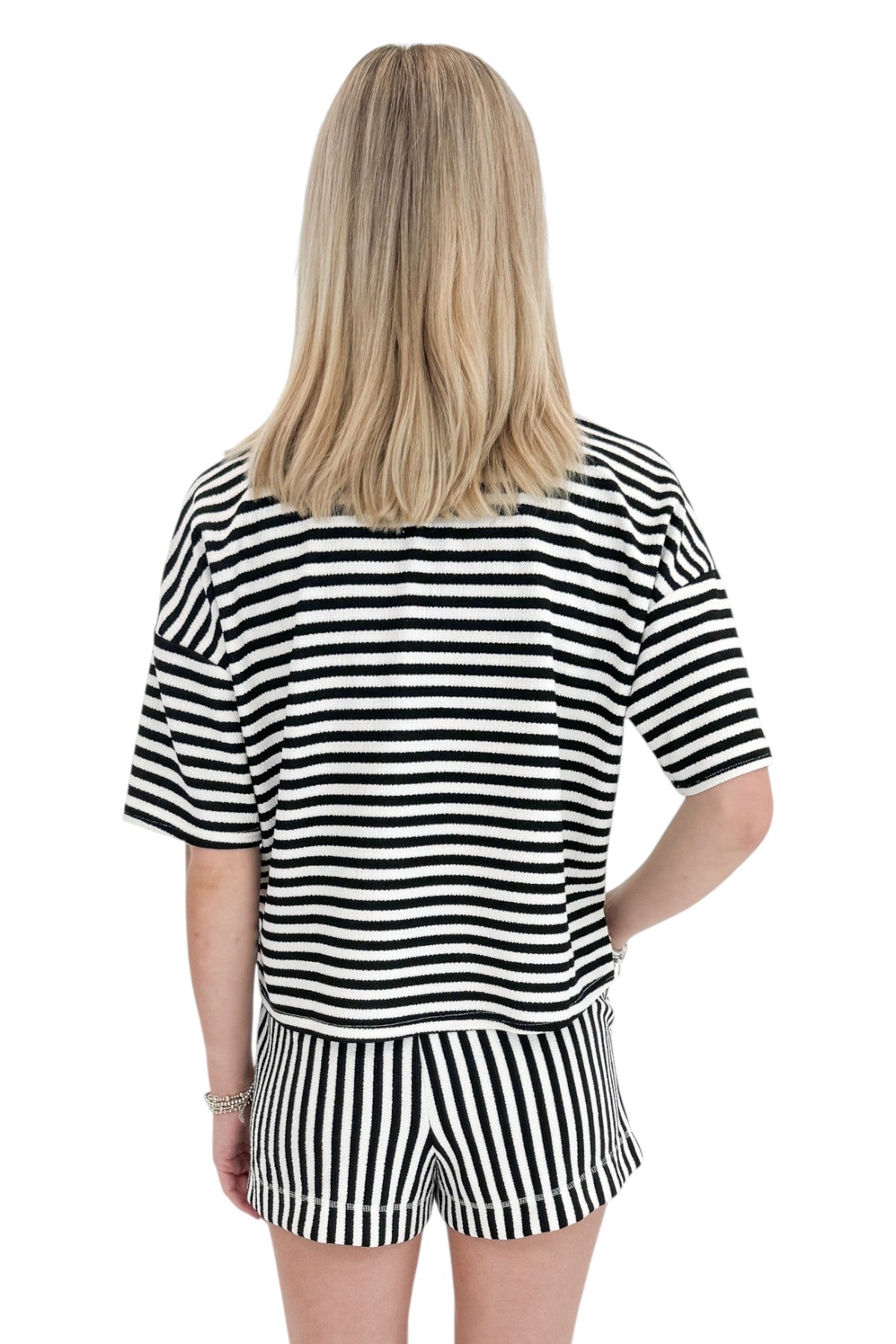 Back view of woman wearing Swagger Boutique’s Black &amp; White Striped Lounge Shorts with matching shorts against white studio background.