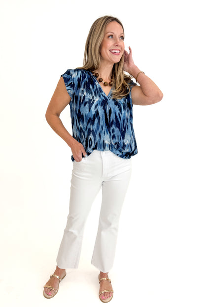 Front view of woman wearing Navy &amp; Blue Printed V-Neck Top with jeans against white studio background.