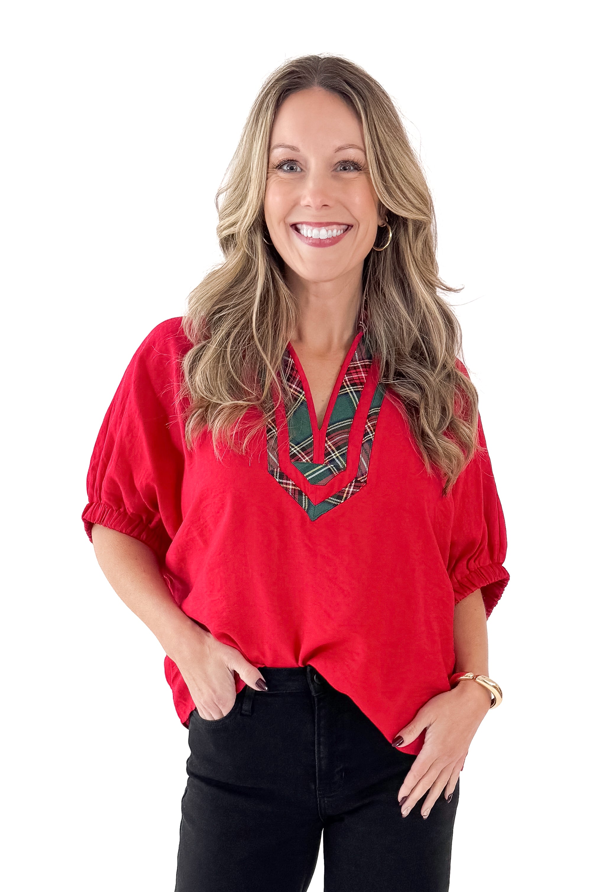 Front view of woman wearing Red With Tartan Lining Dolman Sleeve Top with jeans against white studio background.