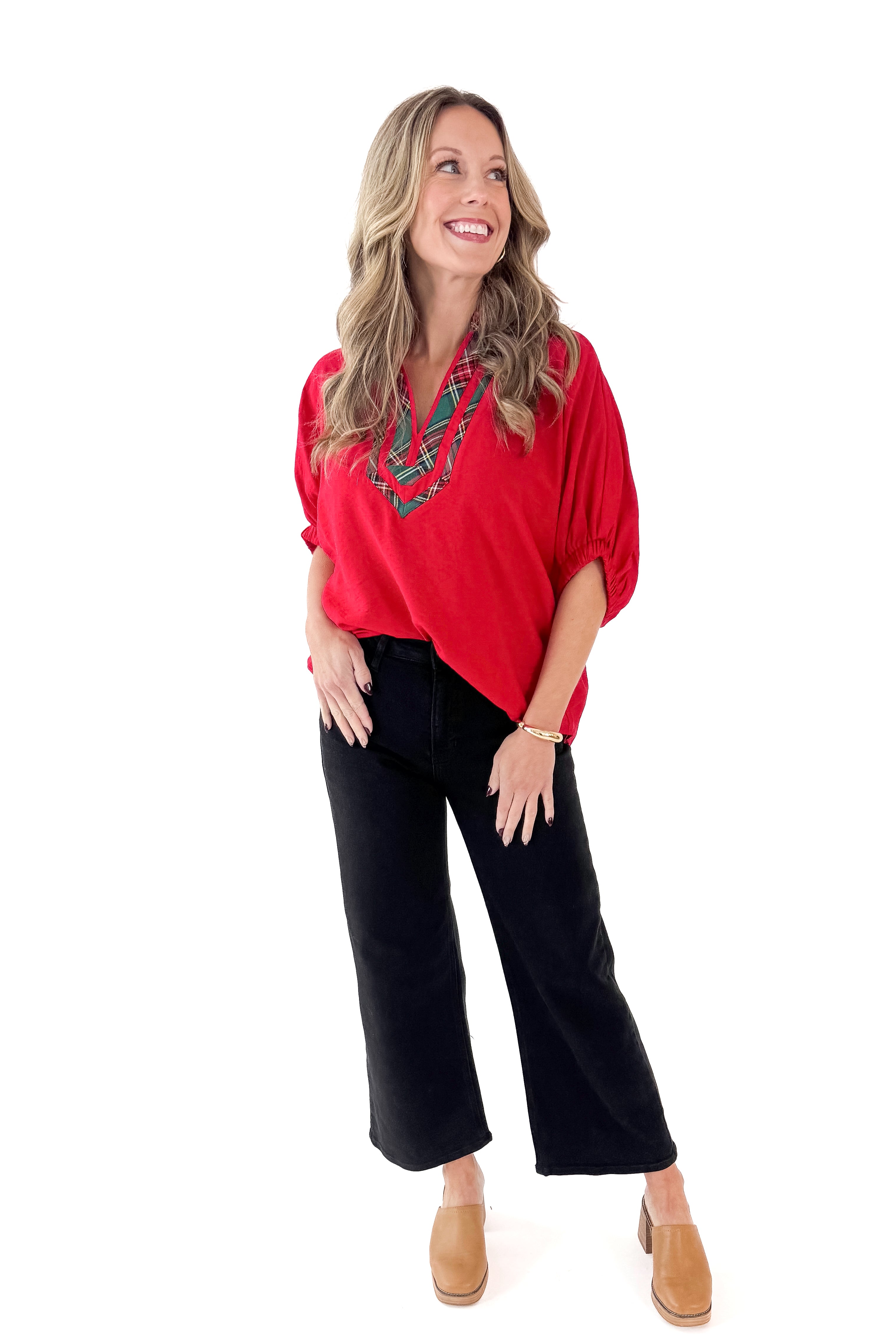 Front view of woman wearing Red With Tartan Lining Dolman Sleeve Top with jeans against white studio background.