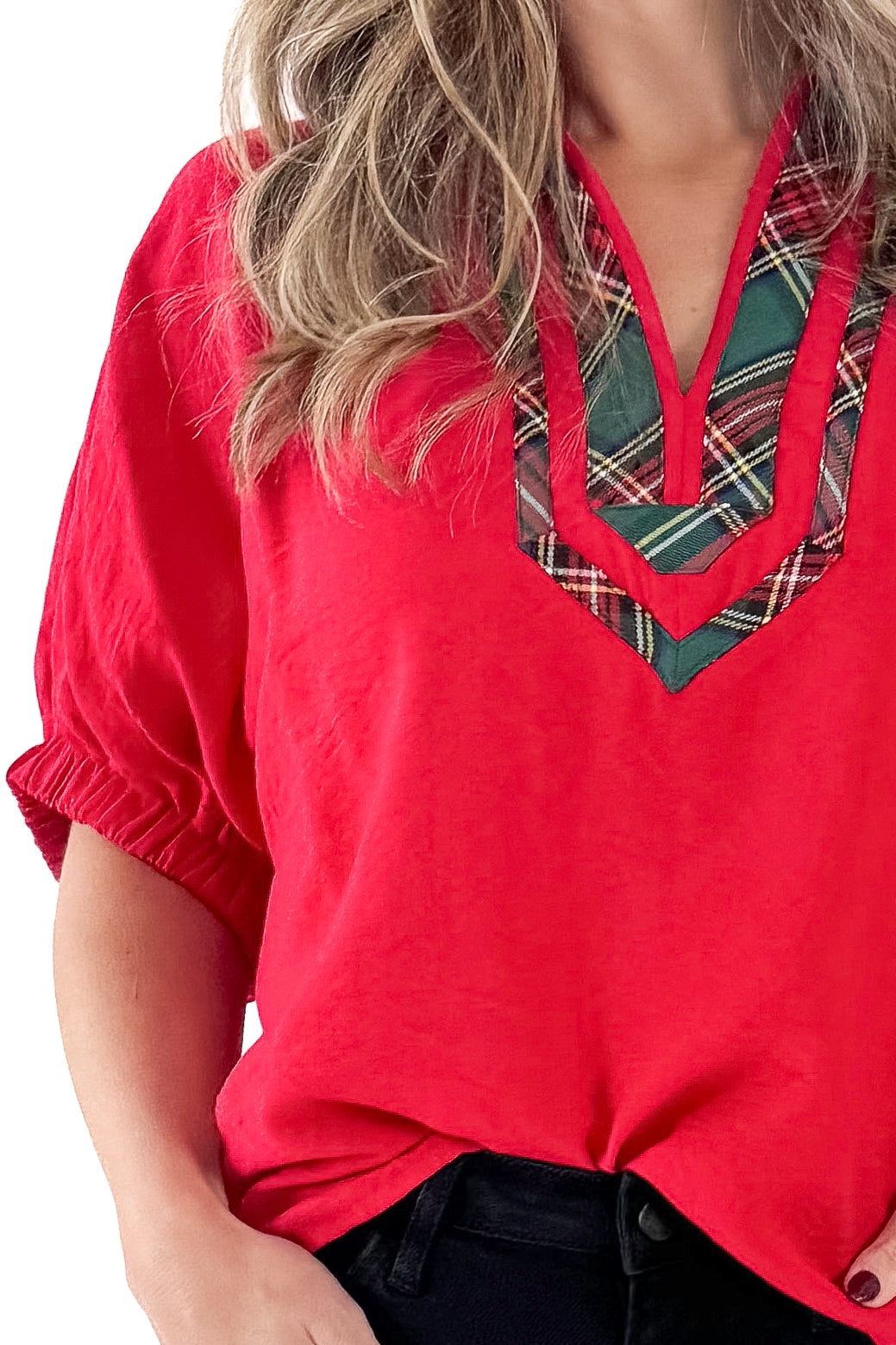 Front detailed view of woman wearing Red With Tartan Lining Dolman Sleeve Top with jeans against white studio background.