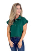 Woman wearing a green sleeveless shirt and blue jeans on a white background