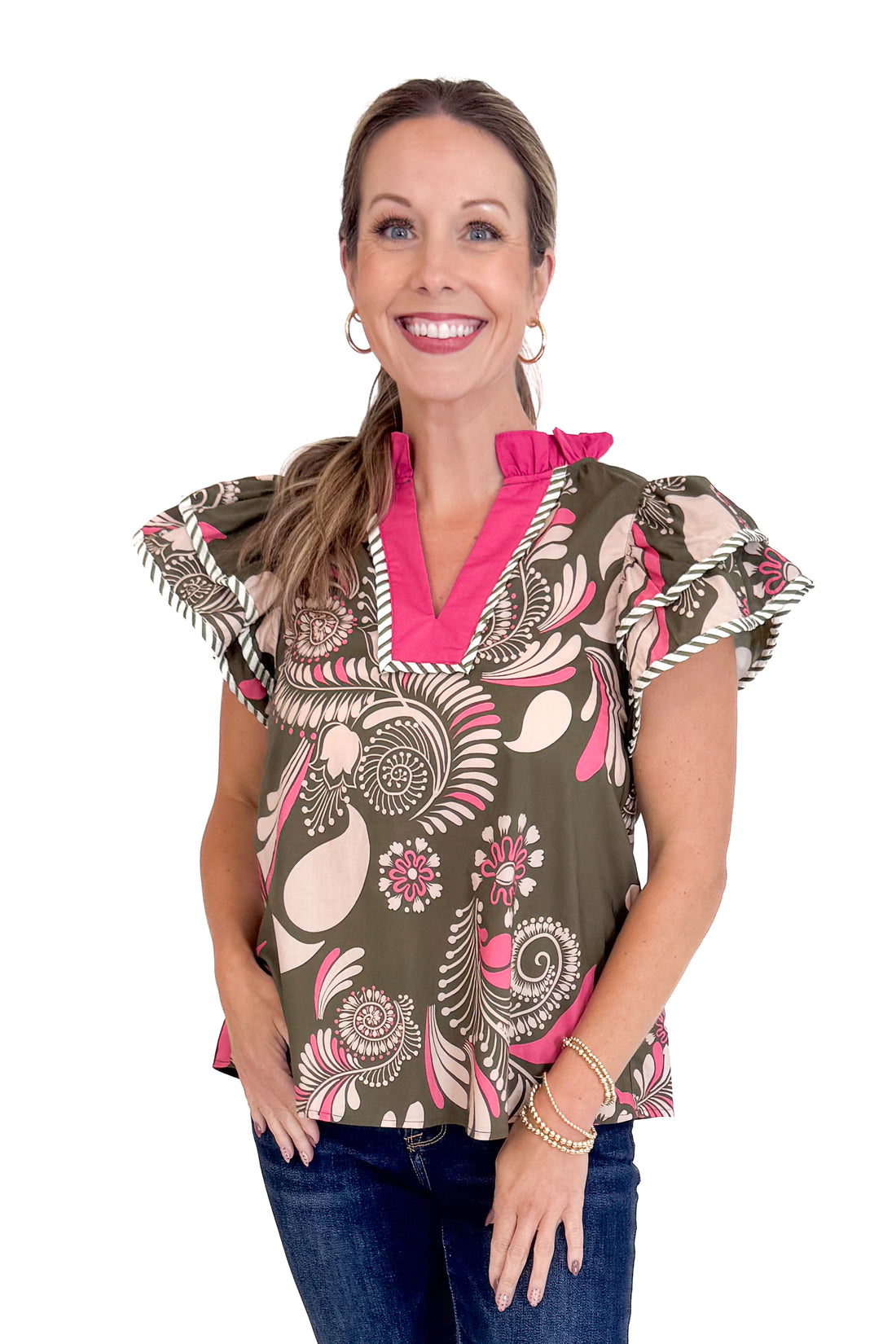 Woman wearing a patterned blouse with a white background