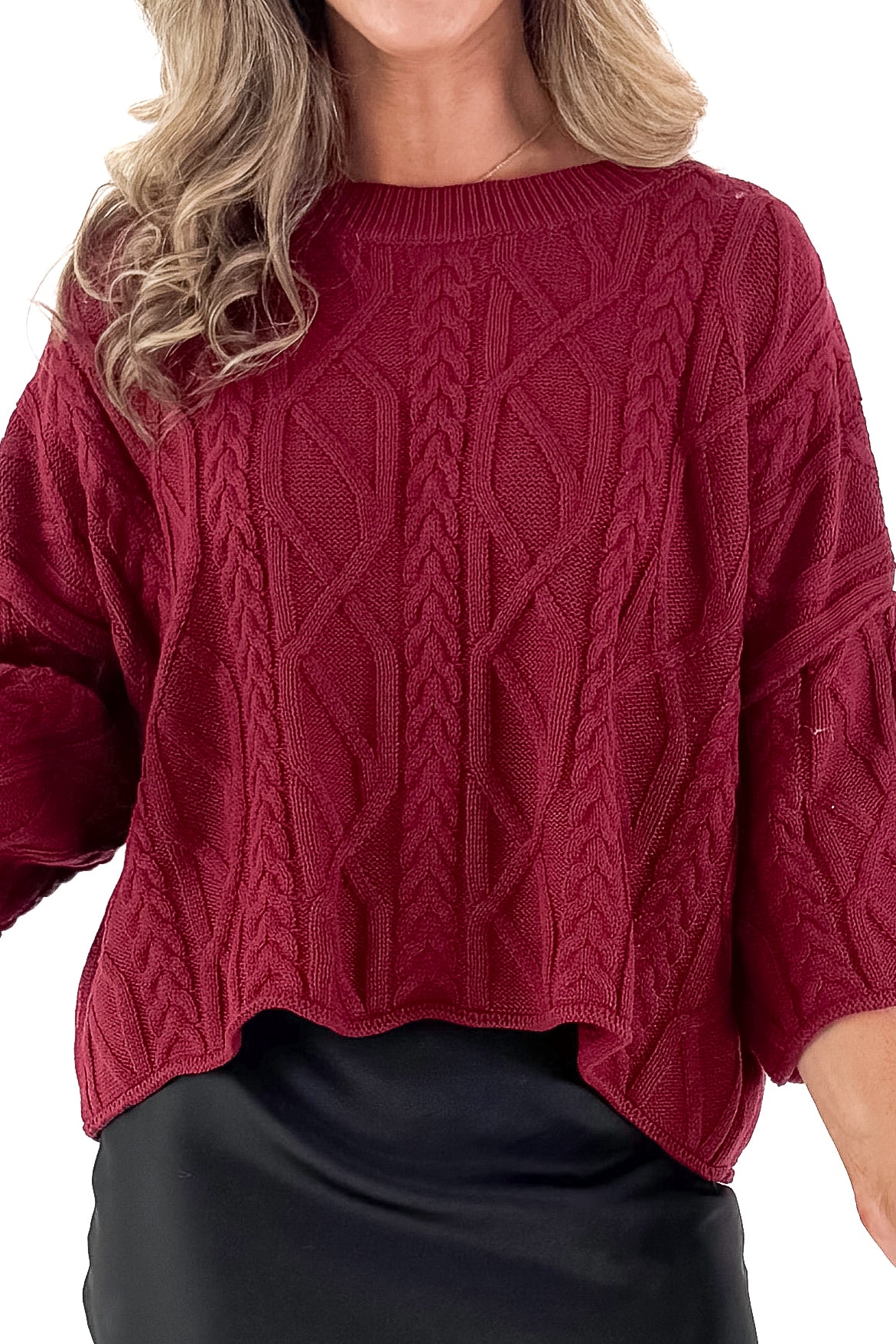 Front detailed view of woman wearing Burgundy Cable Knit 3/4 Sleeve Sweater with black skirt against white studio background.