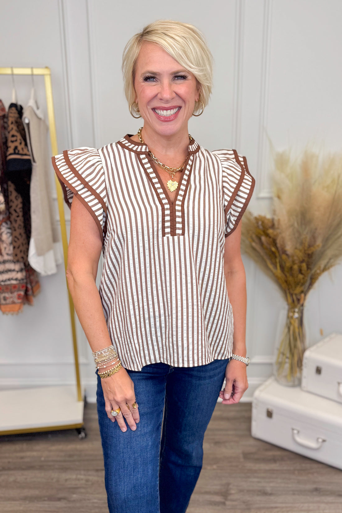Woman wearing Rise &amp; Shine Brown Striped Flutter Sleeve Top by Entro - front view showing brown striped pattern and flutter sleeves