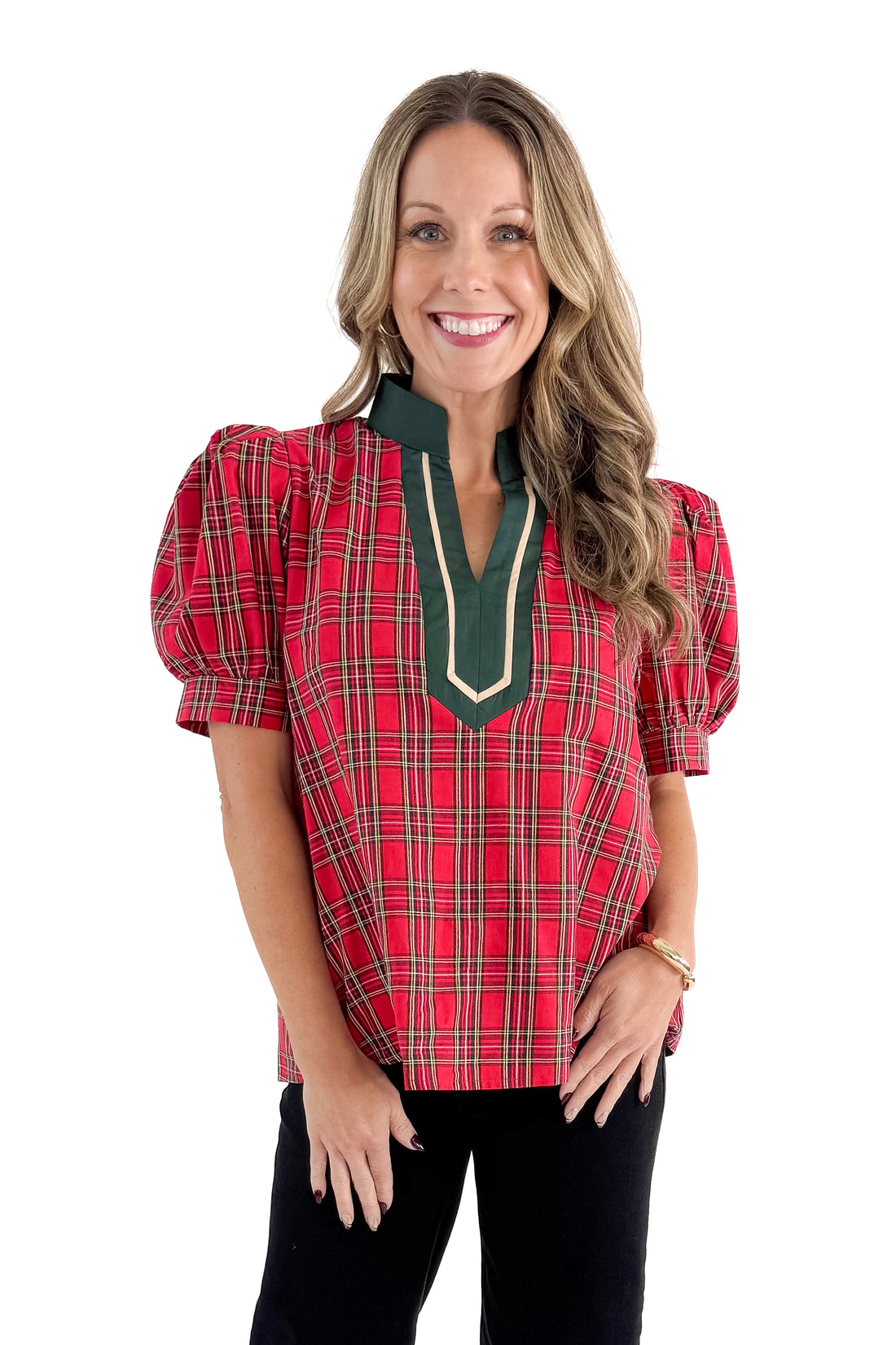 Front view of woman wearing Red Tartan With Green V-neck Detail Top with jeans against white studio background.