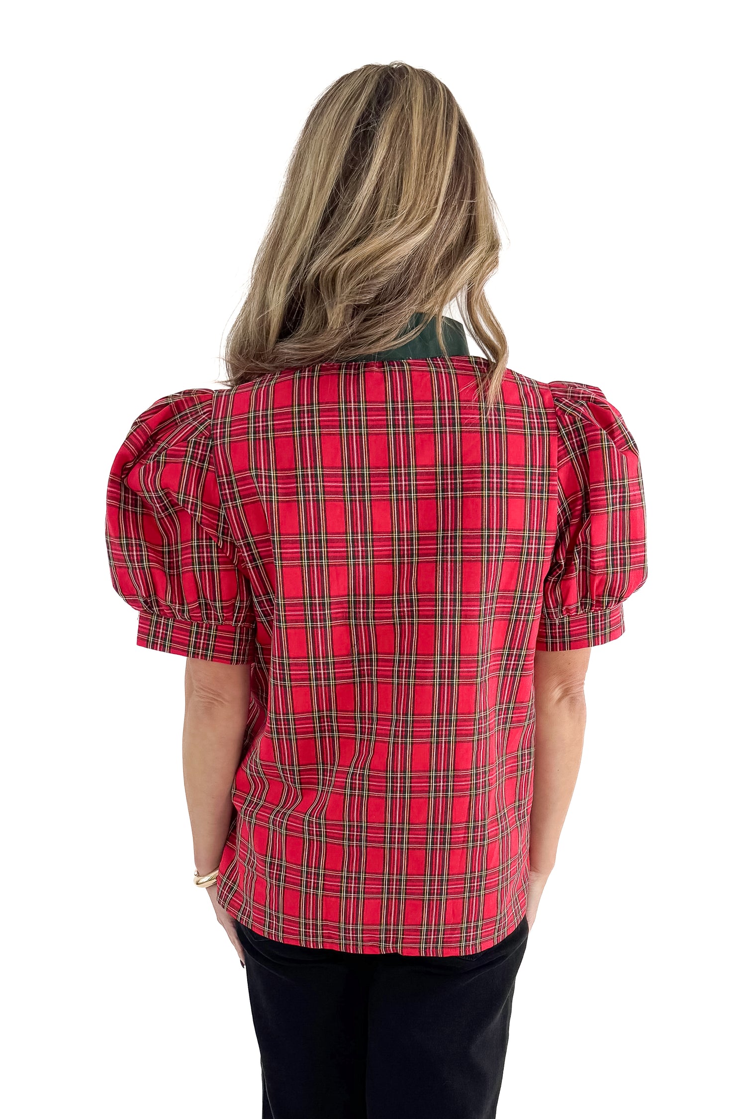 Back view of woman wearing Red Tartan With Green V-neck Detail Top with jeans against white studio background.