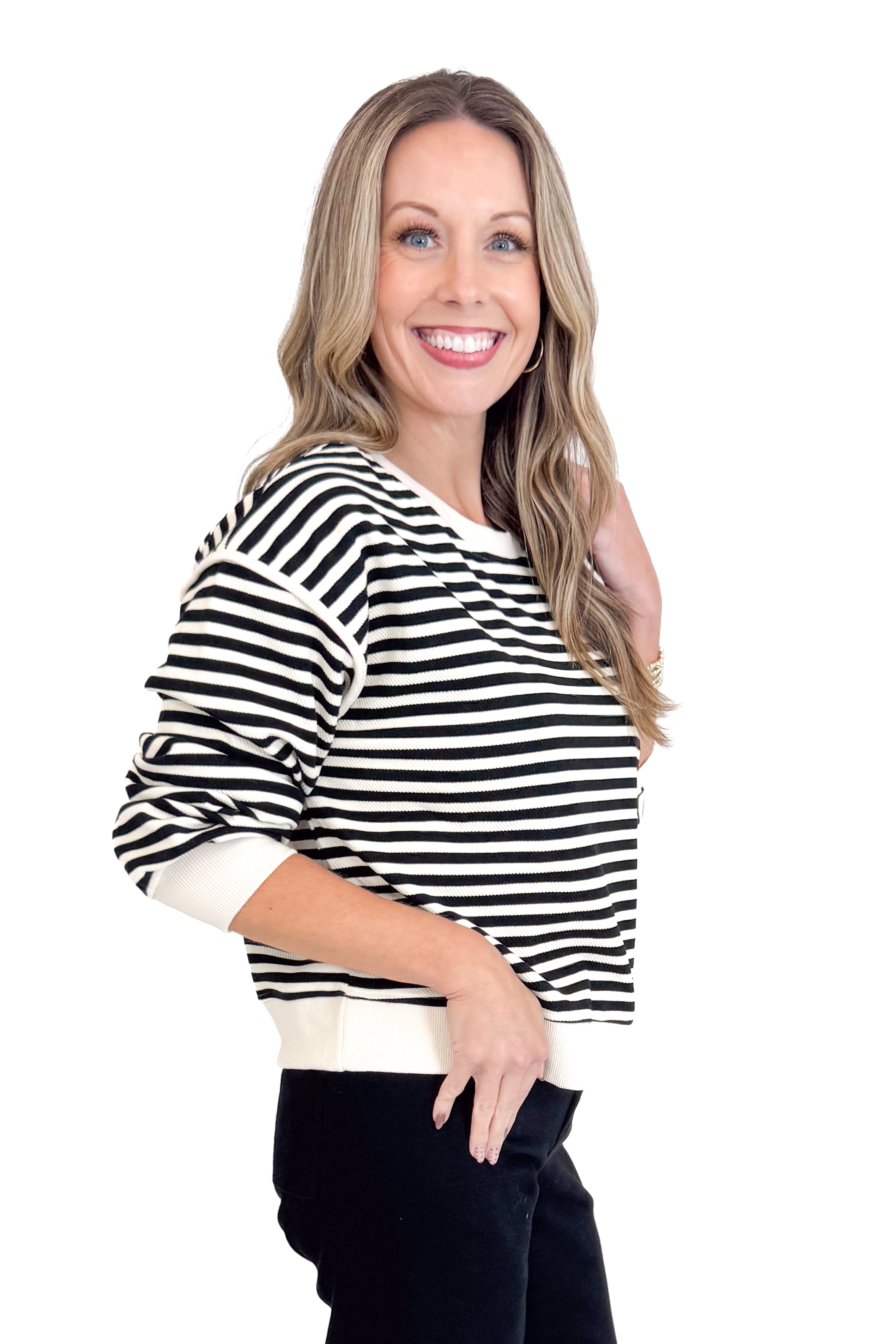 Woman wearing a black and white striped sweater on a white background