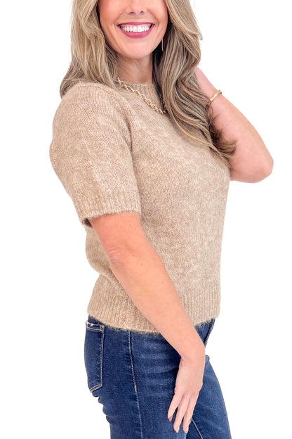 Side view of woman wearing Mocha Short Sleeve Fuzzy Sweater by Entro and blue jeans with white studio background. 