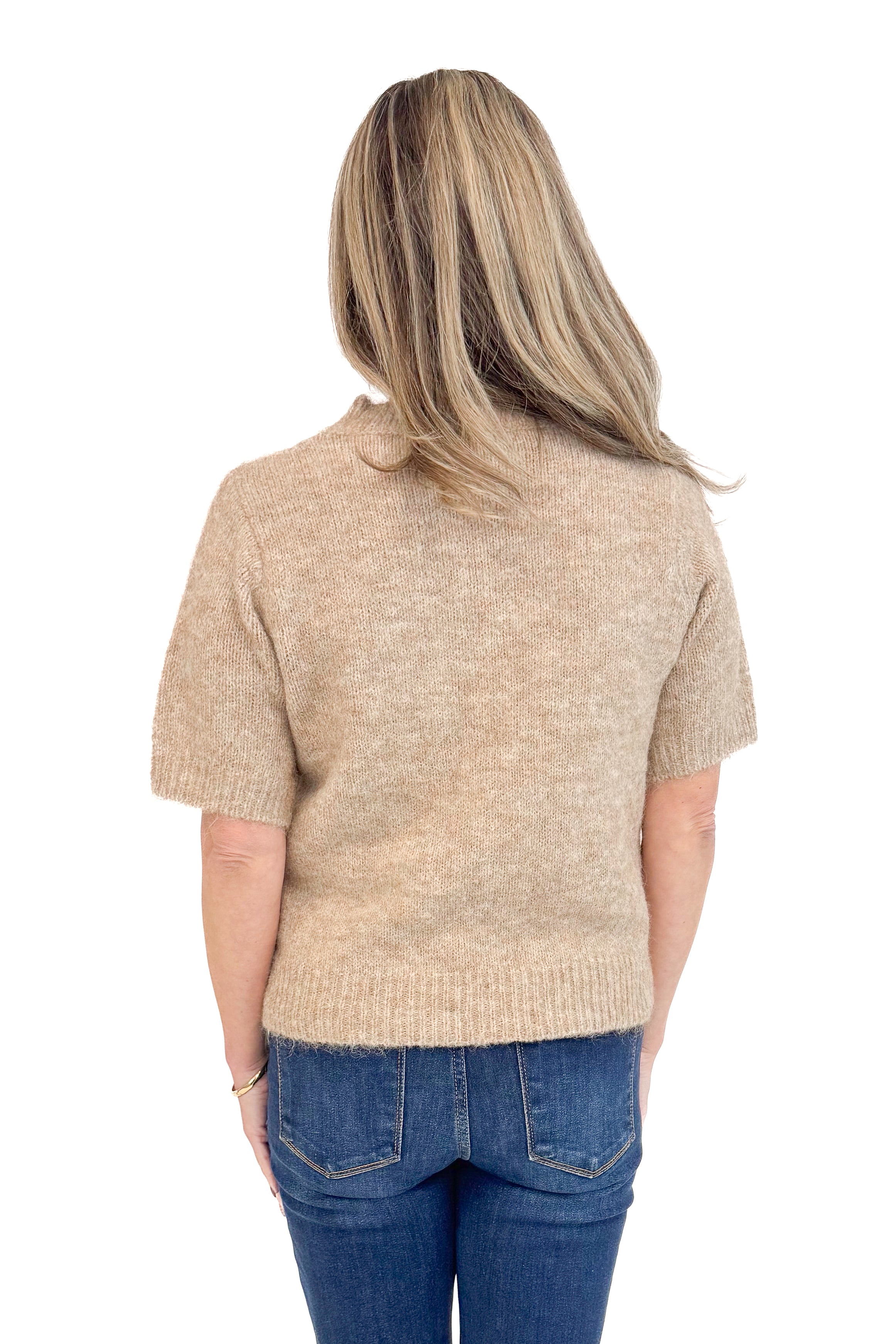 Back view of woman wearing Mocha Short Sleeve Fuzzy Sweater by Entro and blue jeans with white studio background. 