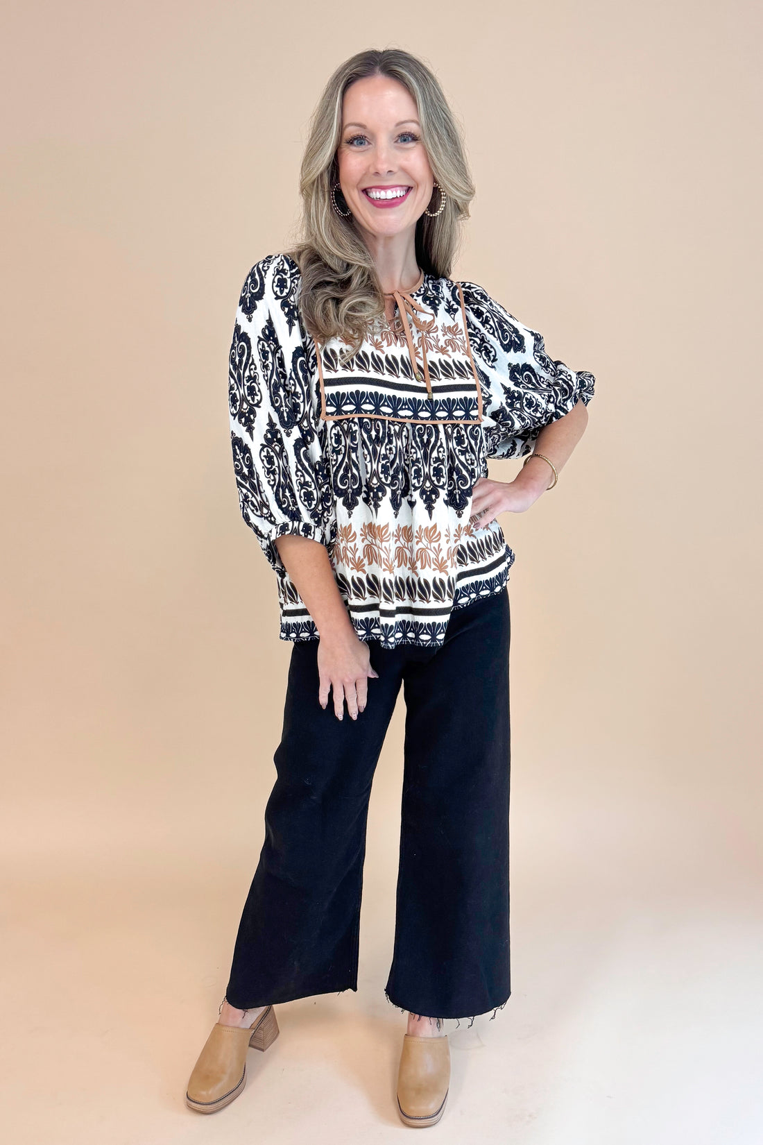 Woman wearing All The Fall Things Black &amp; Brown Printed 3/4 Sleeve Top by Entro - front view showing autumn-themed print and 3/4 sleeves