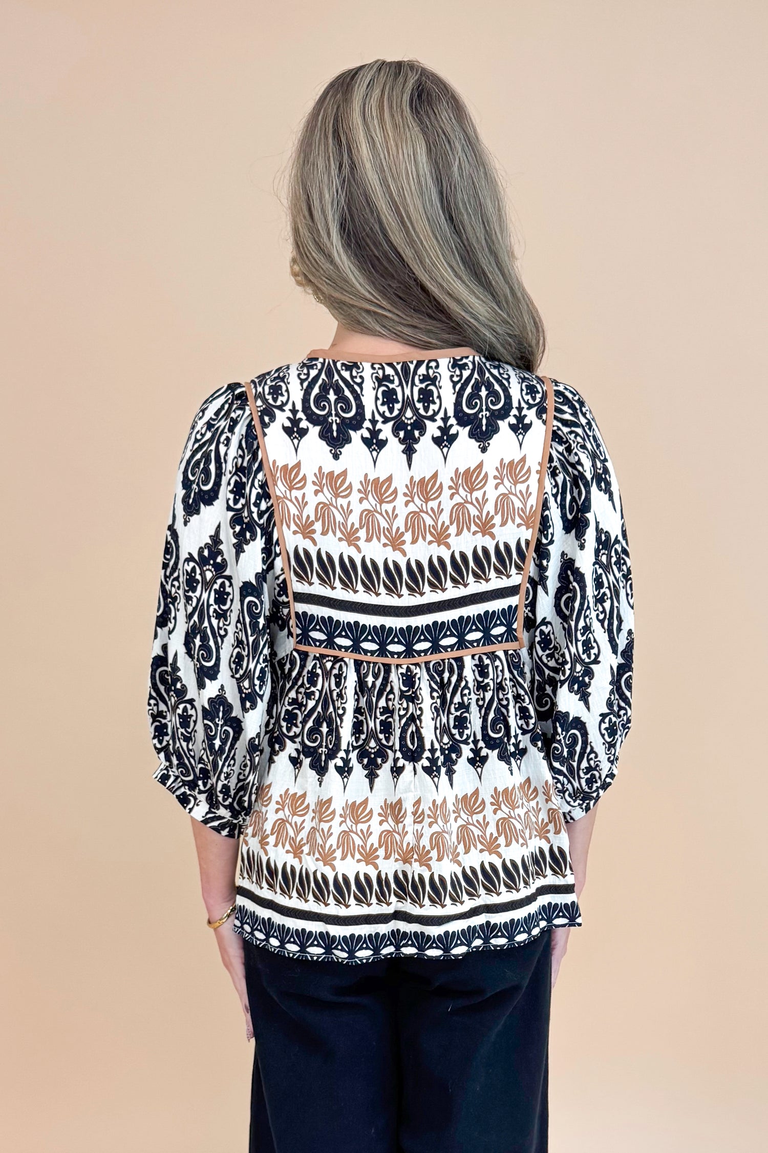 Woman wearing All The Fall Things Black &amp; Brown Printed 3/4 Sleeve Top by Entro - rear view showing autumn-themed print and 3/4 sleeves