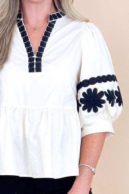 In Good Spirits Ecru With Black Embroidered Sleeve Peplum Top by Entro