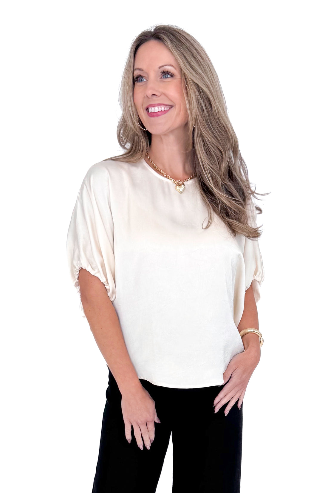 Front view of woman wearing Champagne Satin Tie Sleeve Top with jeans against white studio background.