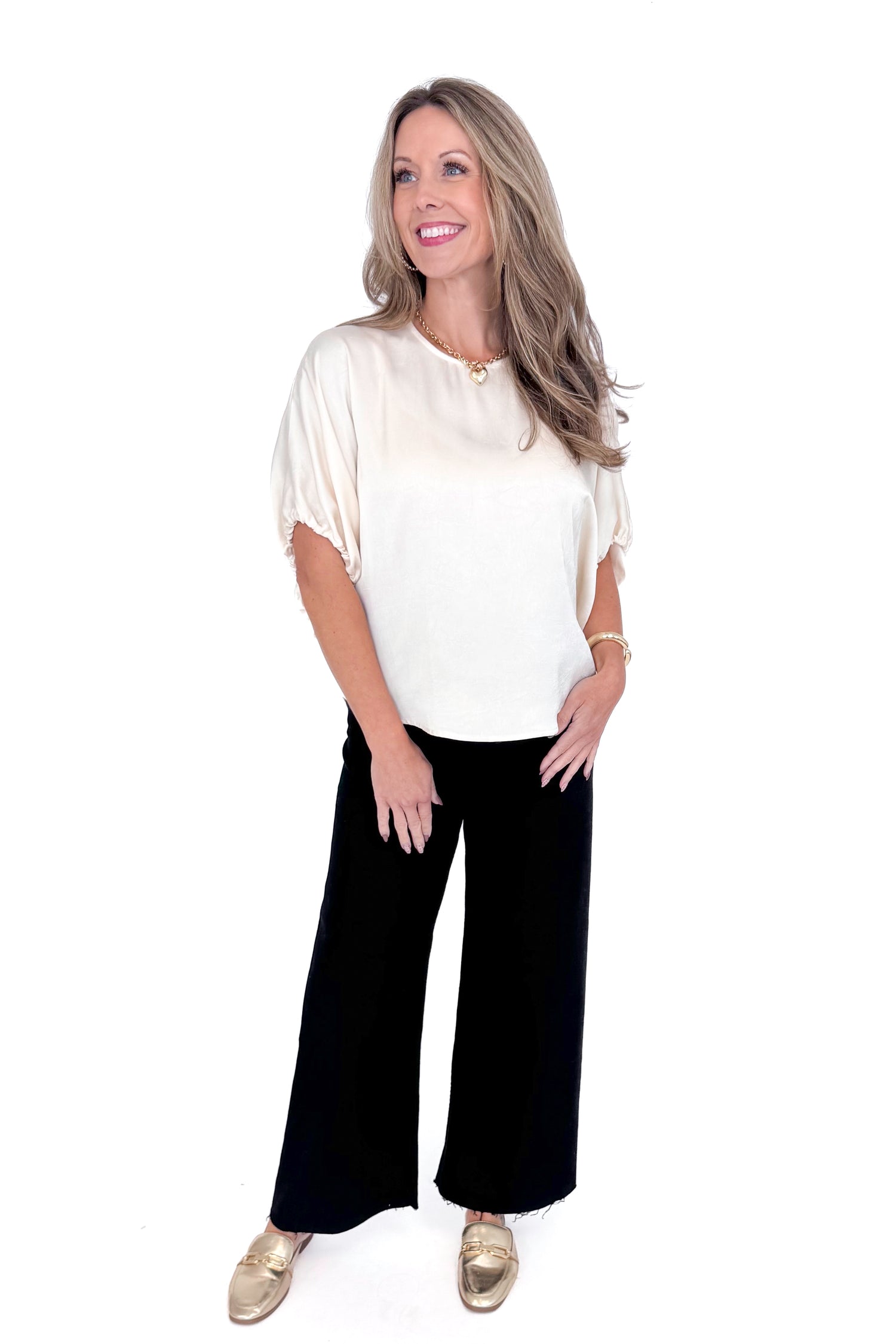 Front view of woman wearing Champagne Satin Tie Sleeve Top with jeans against white studio background.
