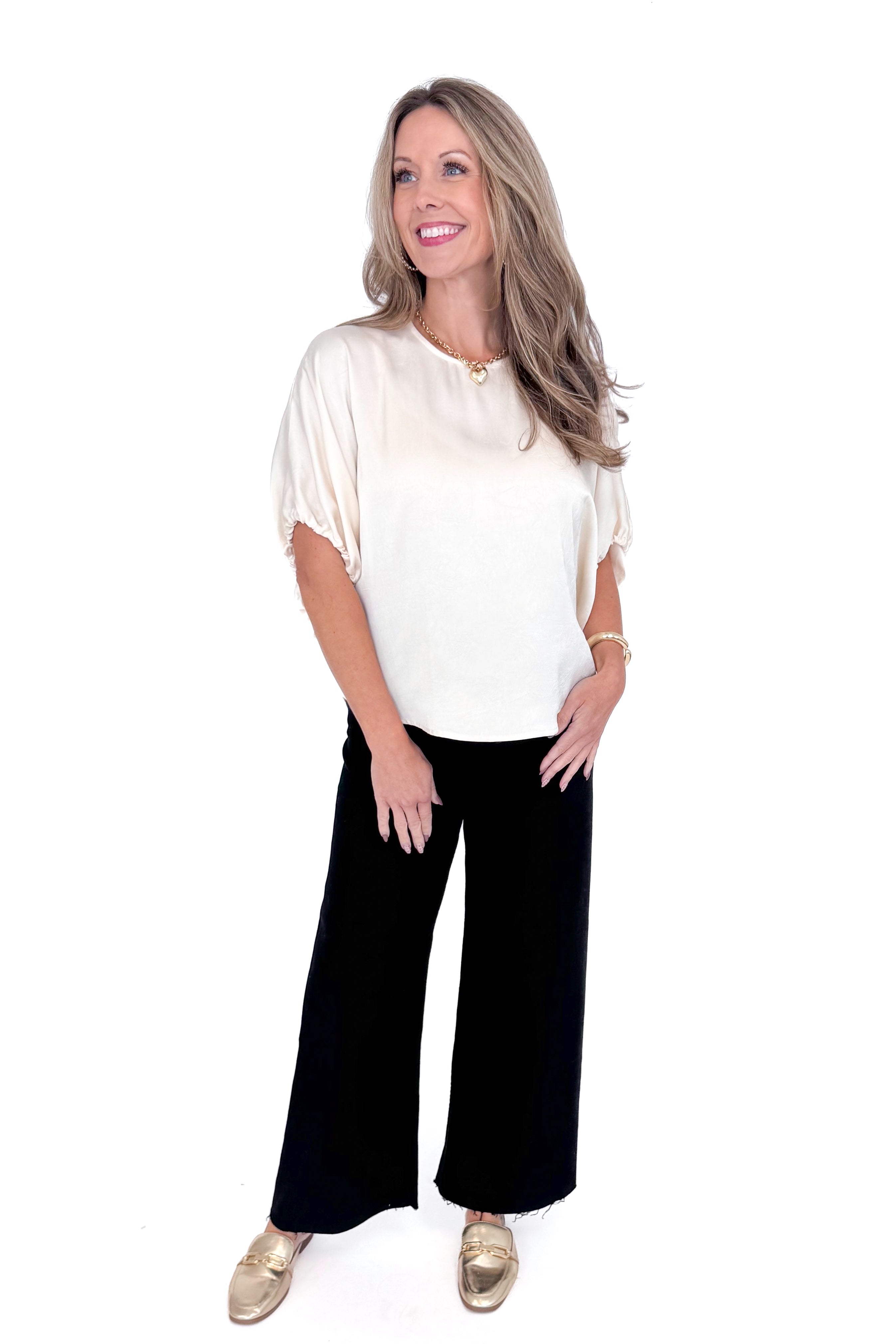 Front view of woman wearing Champagne Satin Tie Sleeve Top with jeans against white studio background.