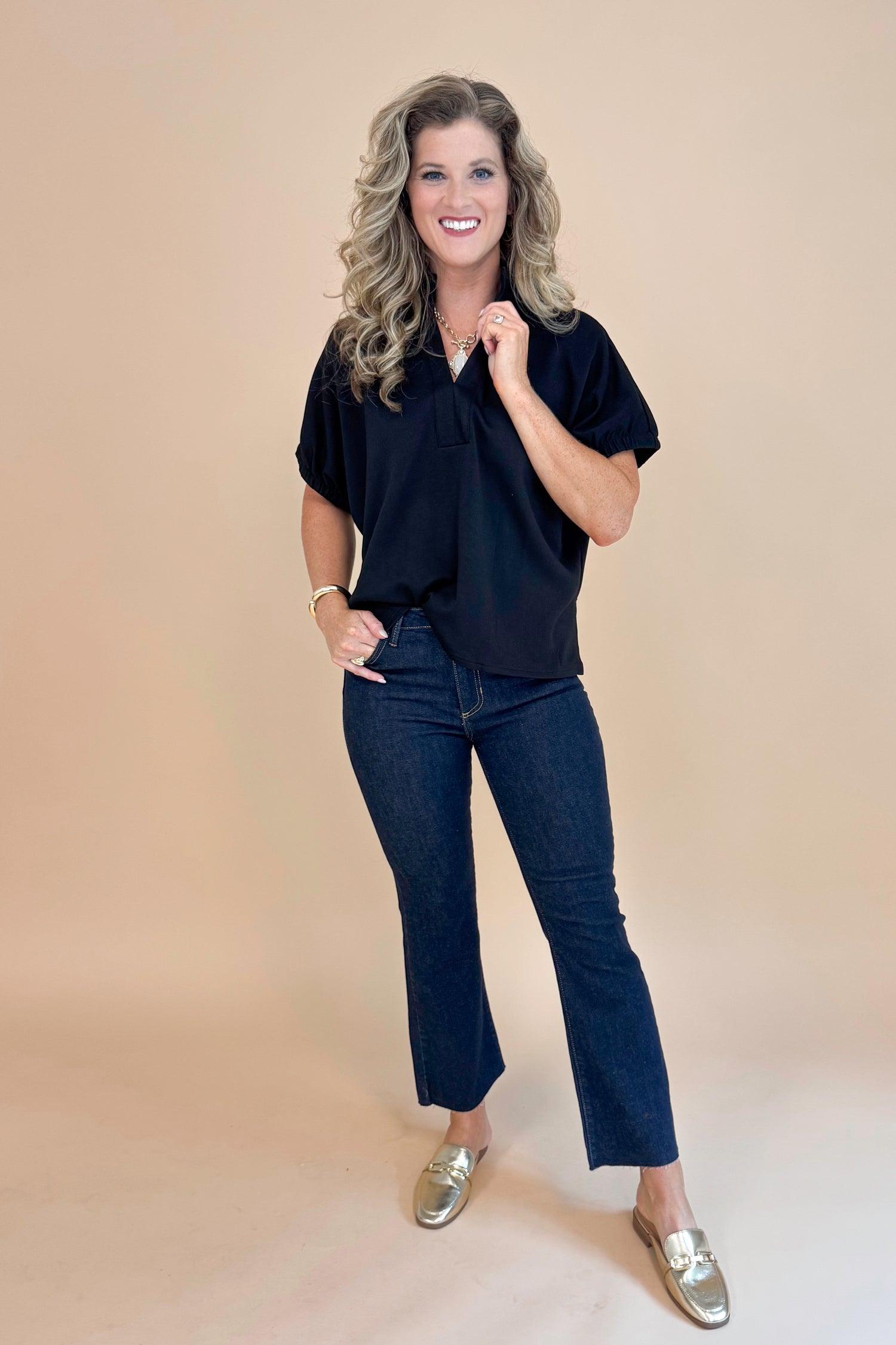 Front view of Black Collared V-neck Top by Entro and blue jeans. 