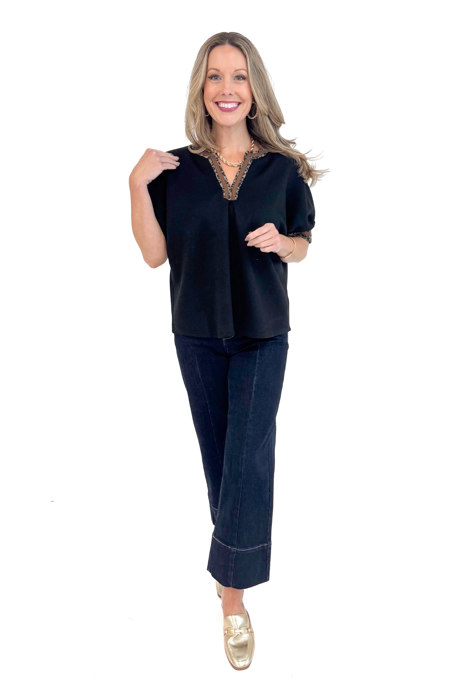 Front full length photo of woman wearing a Black Leopard Lined V-neck Top by Entro.