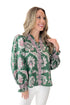 Front view of woman wearing Green & Pink Printed Smocked Center Top with jeans against white studio background.