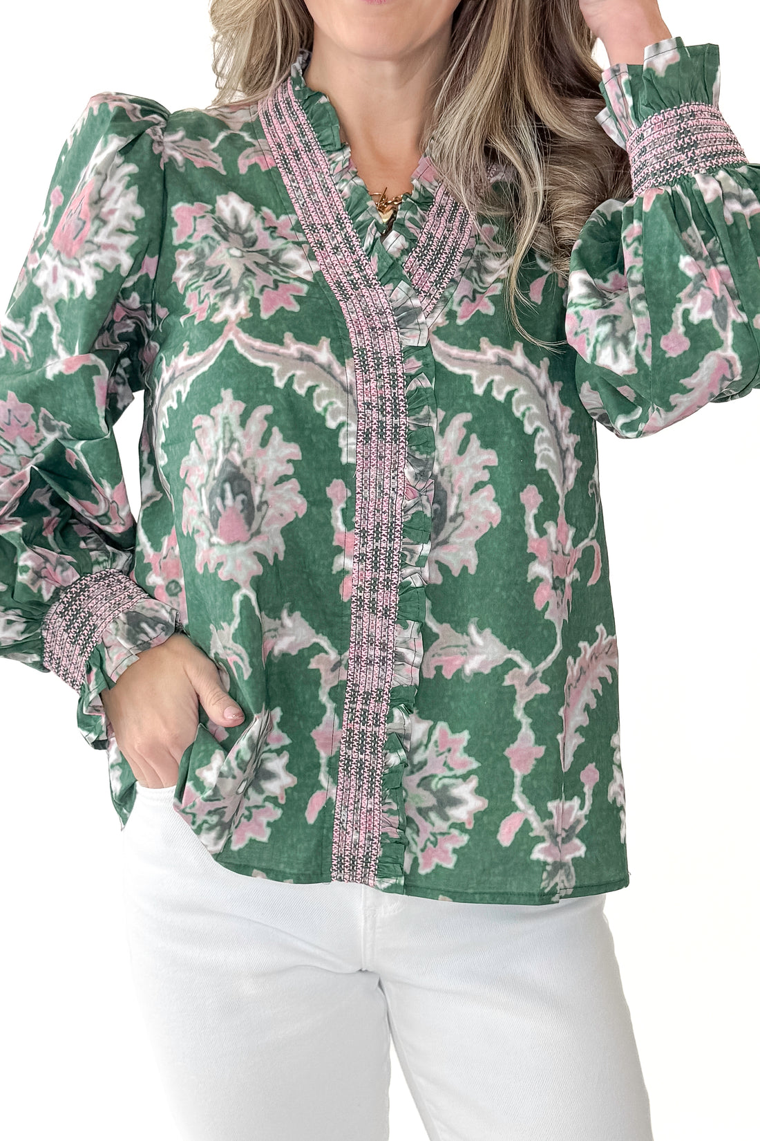 Front detail view of woman wearing Green &amp; Pink Printed Smocked Center Top with jeans against white studio background.