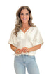 Front view of woman wearing Cream Pleat Detail Dolman Sleeve Top with jeans against white studio background.