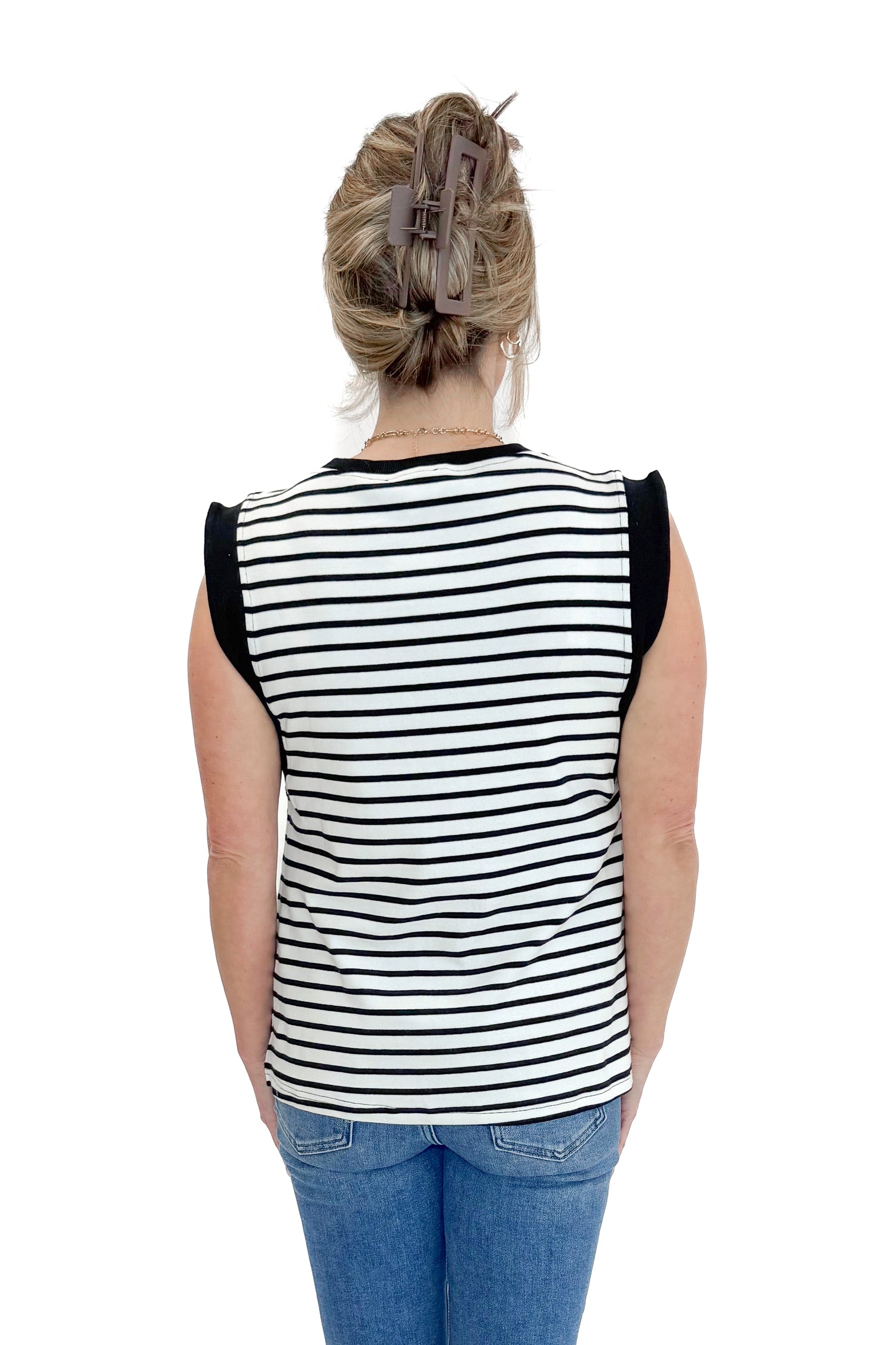 Back view of woman wearing White &amp; Black Striped Sleeveless Top by Entro with jeans against white studio background.