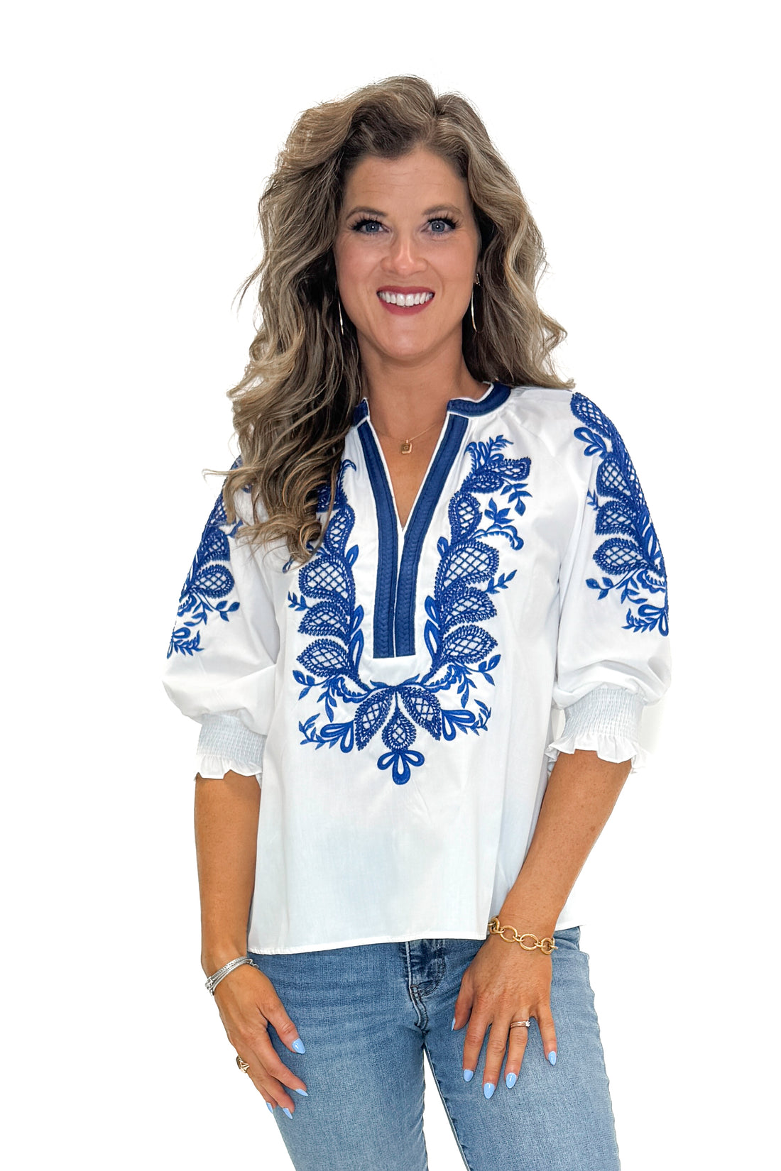 Front view of woman wearing White &amp; Blue Embroidered 3/4 Sleeve Top by Entro with jeans against white studio background.