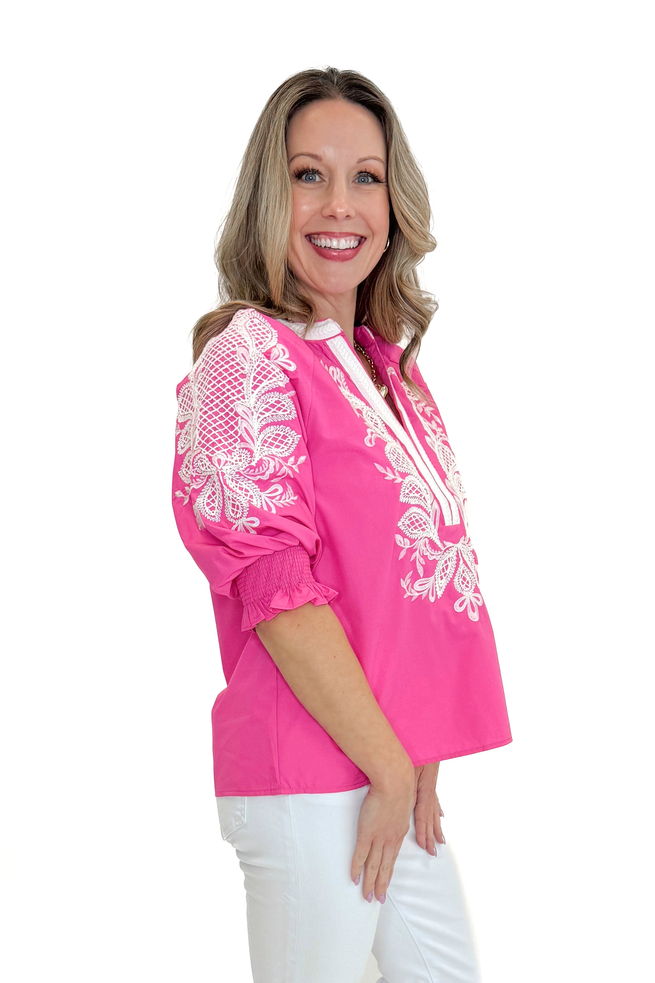 Side view of woman wearing Pink &amp; White Embroidered 3/4 Sleeve Top by Entro with jeans against white studio background.