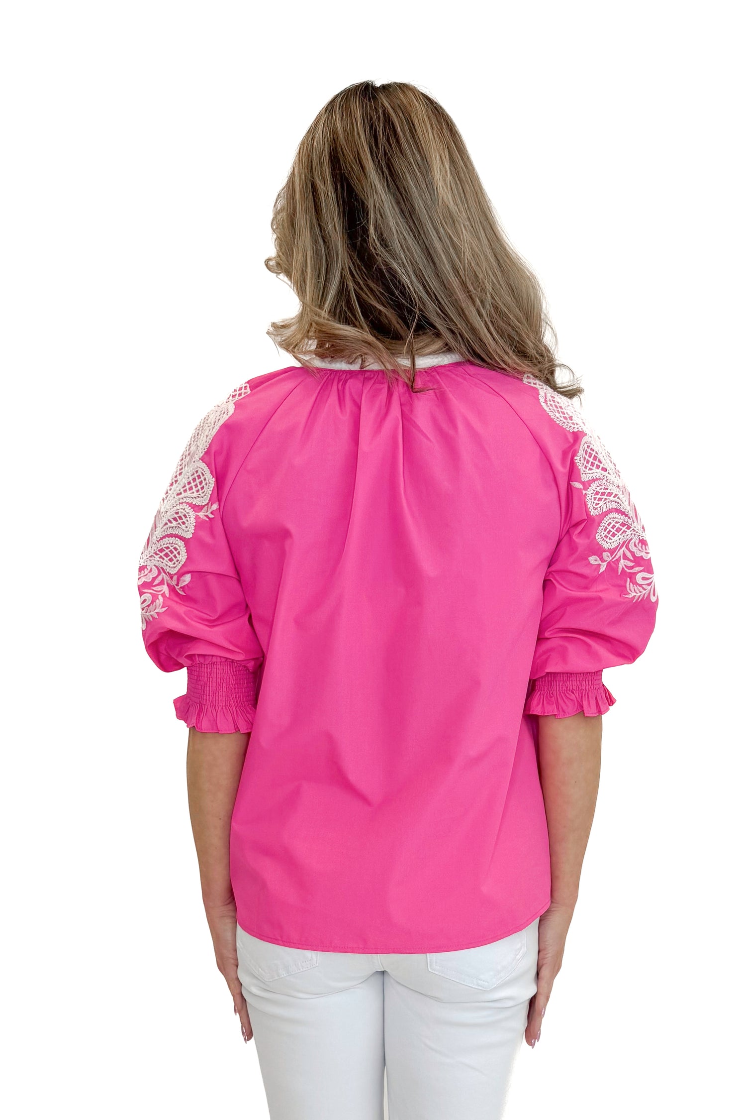 Back view of woman wearing Pink &amp; White Embroidered 3/4 Sleeve Top by Entro with jeans against white studio background.