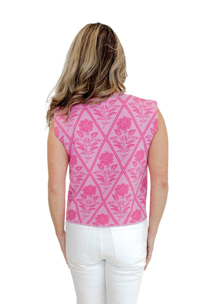 Back view of woman wearing Pink Floral Printed Sleeveless Sweater by Entro with jeans against white studio background.