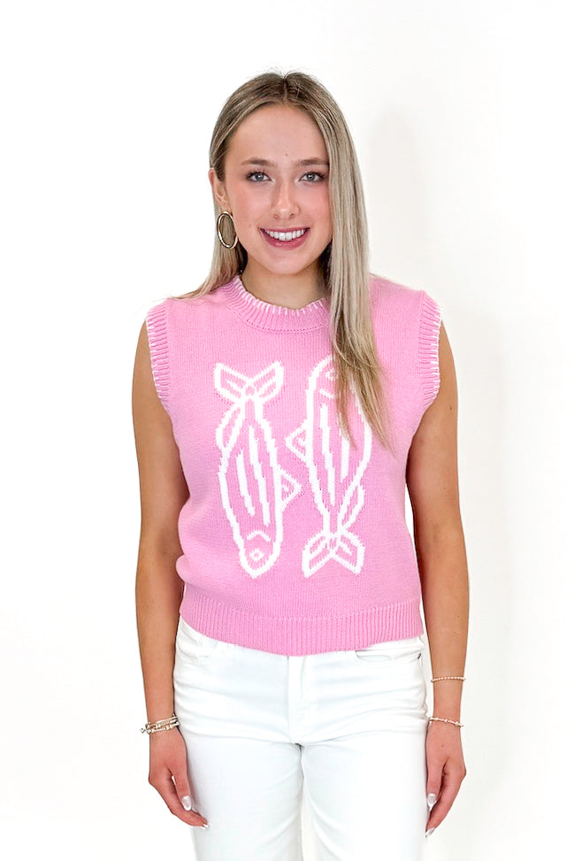 Front view of woman wearing Light Pink Sardine Sweater Tank by Entro with jeans against white studio background.