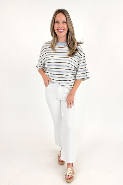 Front view of woman wearing Light Blue &amp; Navy Striped Top by Entro with jeans against white studio background.