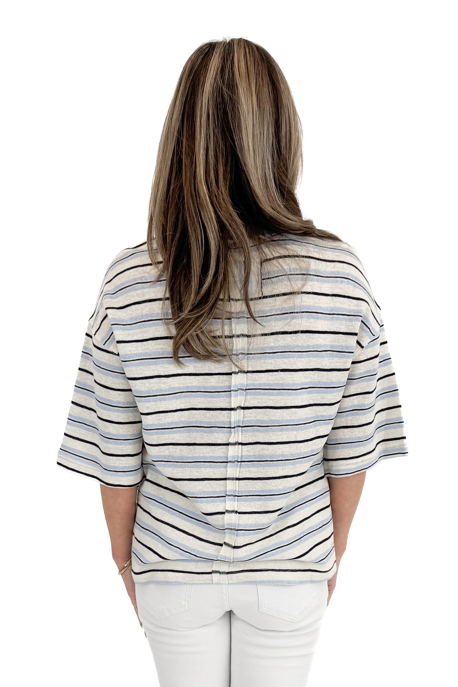 Back view of woman wearing Light Blue &amp; Navy Striped Top by Entro with jeans against white studio background.