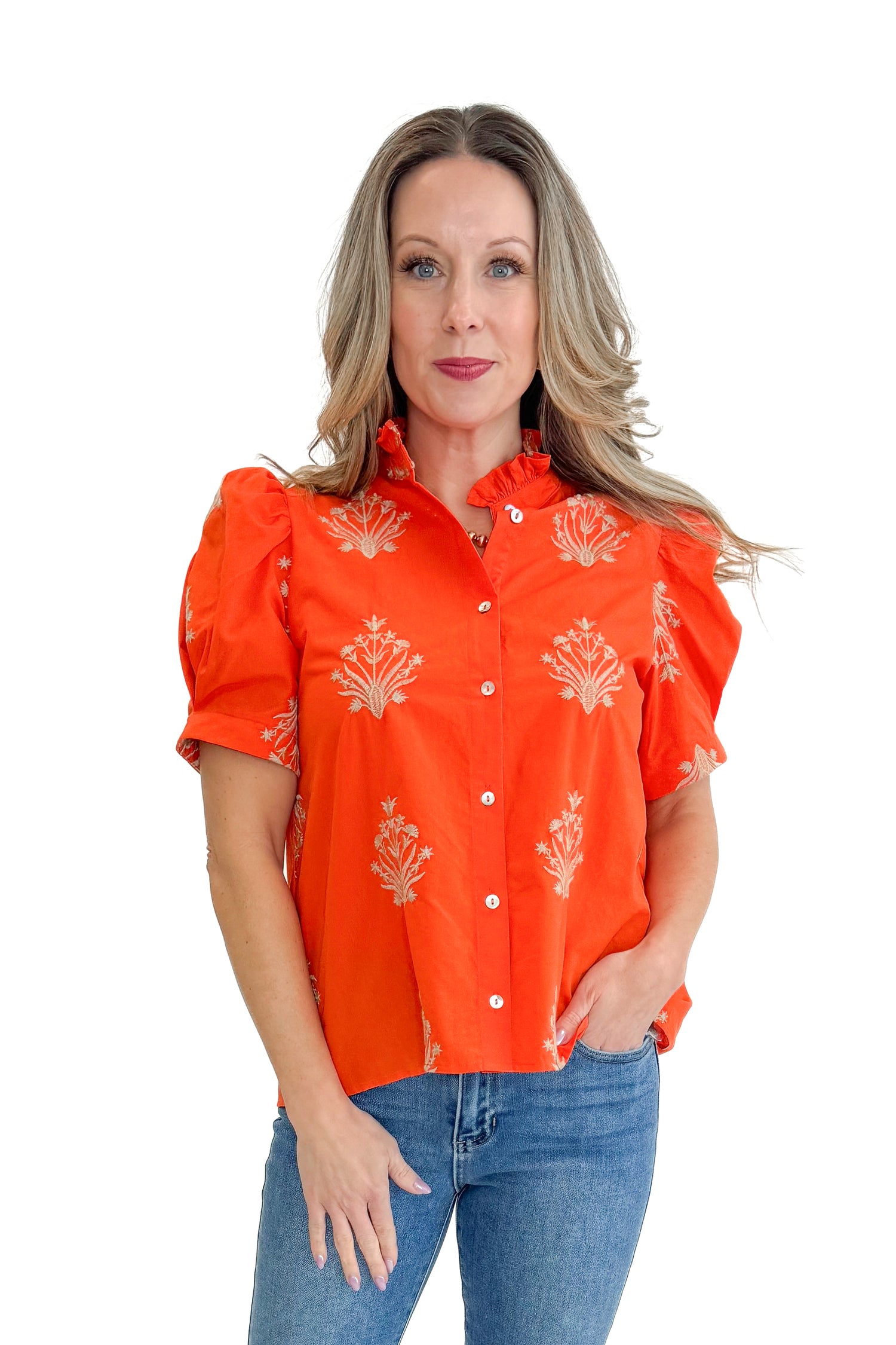 Front view of woman wearing Orange Embroidered Button Up Top by Entro with jeans against white studio background.